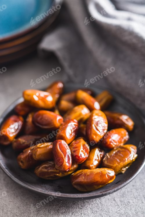 Preview: Dried dates fruit on plate.