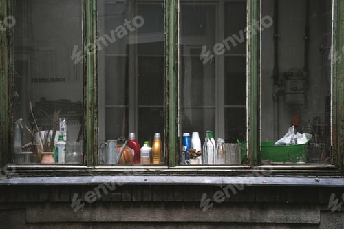 Preview: Kitchen through aged weathered windows with laundry products on the table