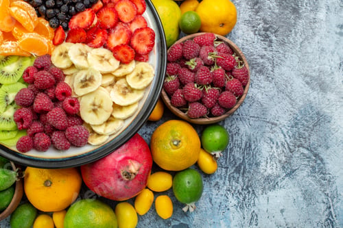 Preview: top view tasty sliced fruits with fresh vegetables on the gray background exotic color fruit ripe