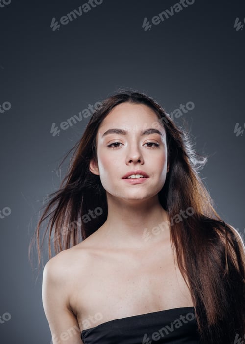 Preview: Beautiful woman smooth long hair brunette natural make up beautiful female portrait dark background