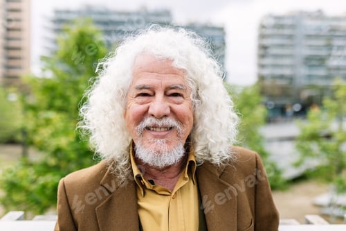 Preview: Happy senior man smiling at camera standing over urban background