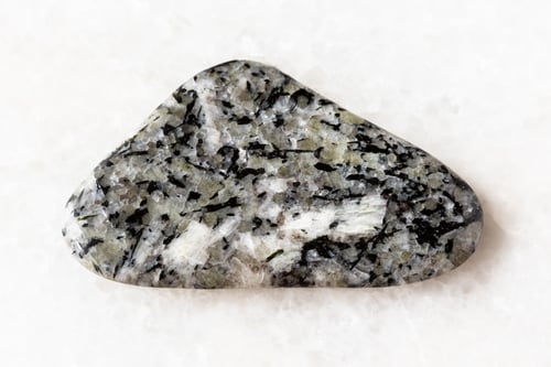 Preview: sample of polished foyaite mineral on white marble