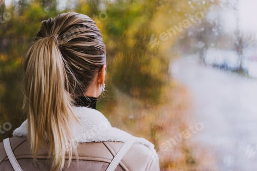 Preview: Thoughtful woman looking throught the window. Raindrops, Rainly street, golden autumn, sunlight