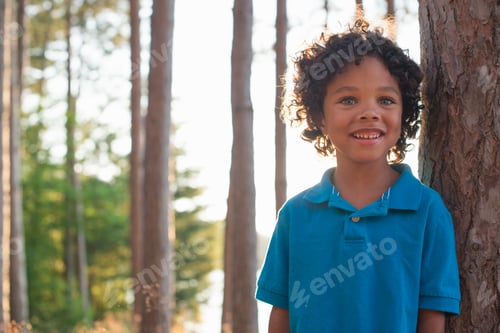 Preview: Trees on the shores of a lake. A child standing among the trees.