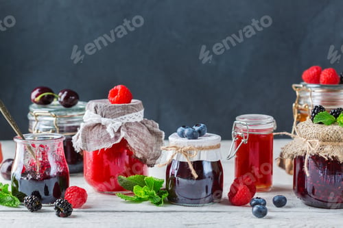 Preview: Assortment of seasonal berries and fruits jams in jars