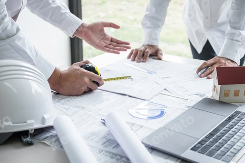 Preview: Construction engineering or architect discuss a blueprint while checking information on drawing and