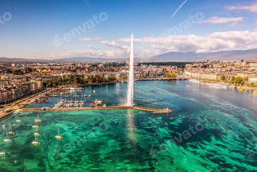Preview: Scenic aerial view of Geneva's water fountain with boats in the foreground.