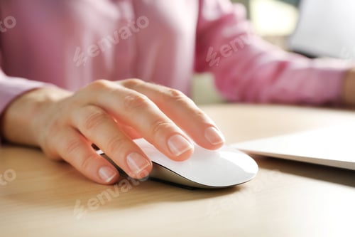 Preview: Woman using computer mouse with laptop at table, closeup