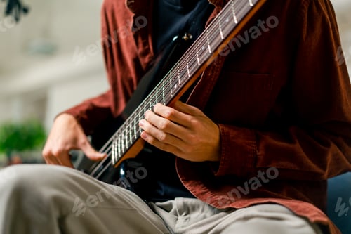 Preview: musician with electric guitar in recording studio plays musical instrument presses fingers strings