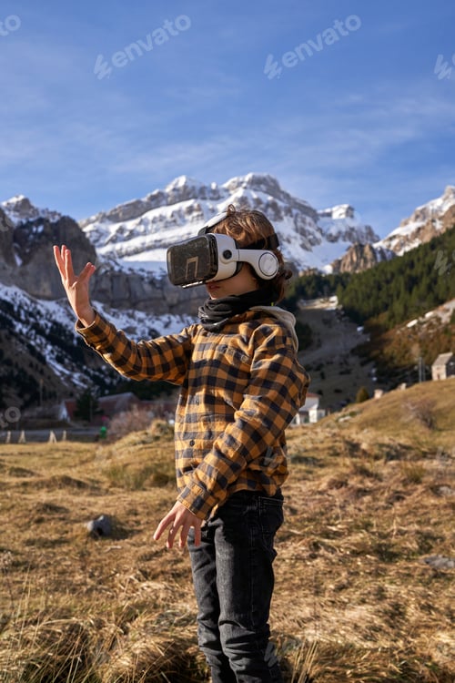 Preview: Preteen boy in virtual reality goggles simulating motion in moun