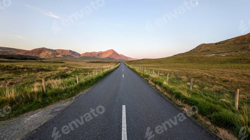 Preview: Empty scenic road trough nature and mountains at sunset, Inagh valley, Connemara, Galway, Ireland, l