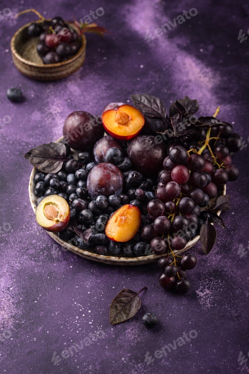 Preview: Assortment of purple fruit plum, grape, blueberry and basil