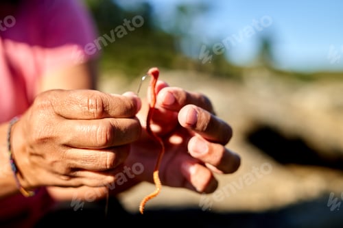 Preview: A person holding a piece of fruit in their hands during a family fishing trip