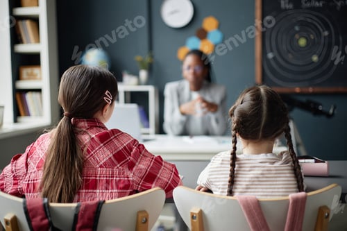 Preview: Two Young Caucasian Girls Listening to Female Teacher Explaining Astronomy Lesson