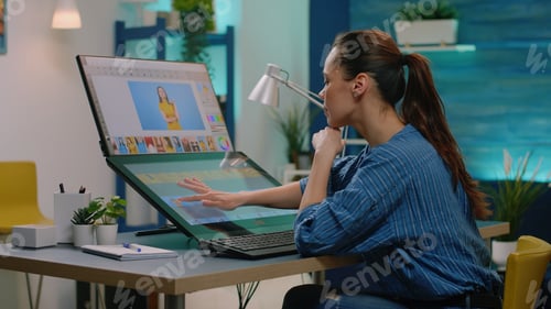 Preview: Editing artist doing retouch work on pictures using touch screen