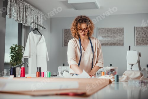 Preview: Professional female tailor over work desk at fashion design workshop