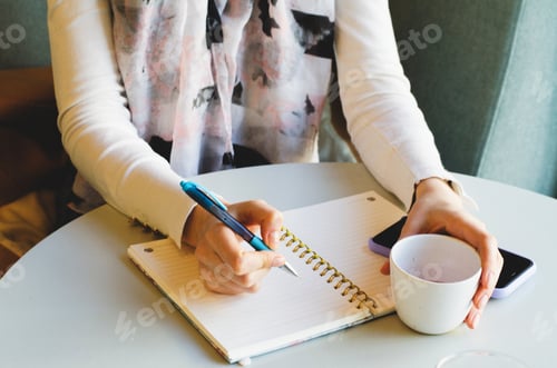 Preview: Girl writes in a notebook. Business woman