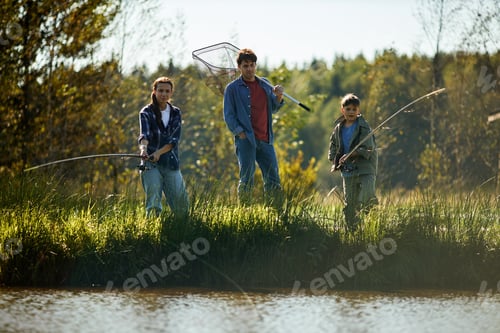 Preview: Caucasian Father with Teenager Daughter and Son Fishing Together Outdoors