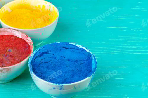 Preview: Bows of colorful Holi power close up on floor