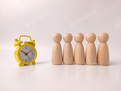 Preview: Six wooden peg doll figures lined up alongside a yellow alarm clock