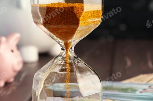Preview: Time and money business concept. Sandglass and money