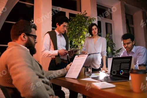 Preview: Colleagues working together in modern office using devices and gadgets during creative meeting