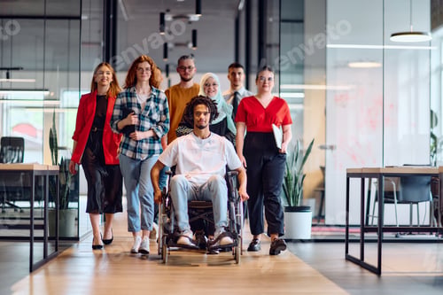 Preview: A diverse group of young business people walking a corridor in the glass-enclosed office of a modern