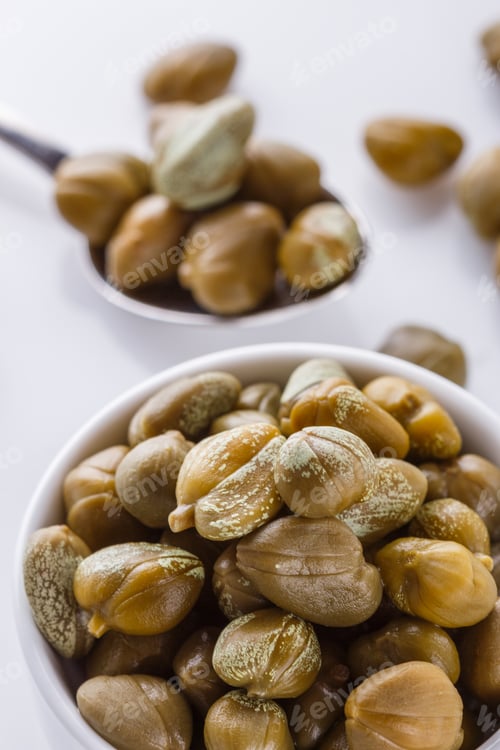 Preview: Pickled capers on a white acrylic background