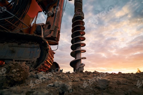Preview: Building activity on construction site. Close-up view of drilling machine.
