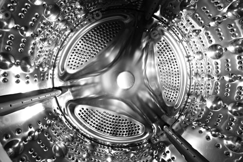 Preview: Inside of a shine steel drum of the washing or dryer machine. Laundry day. Daily househol