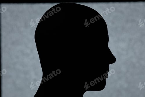 Preview: Silhouette of Mans Head against Grey Background in Studio