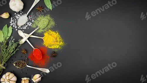 Preview: Various spices and herbs in spoons on a dark table. Spices for food. Food background.Copy space.