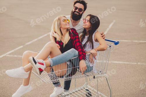 Preview: Group of happy hipsters with shopping cart