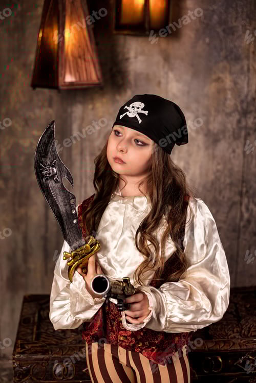 Preview: Smiling little girl actress 7-8 year old in pirate's image with gun and saber at gray