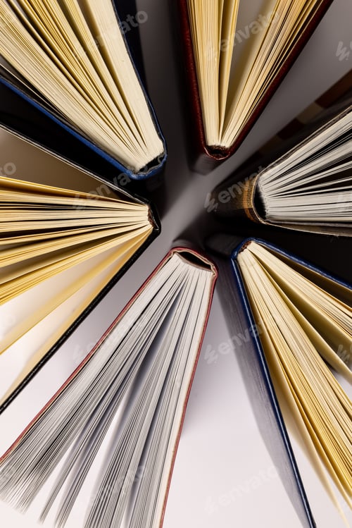 Preview: Image of central composition with books standing on white surface