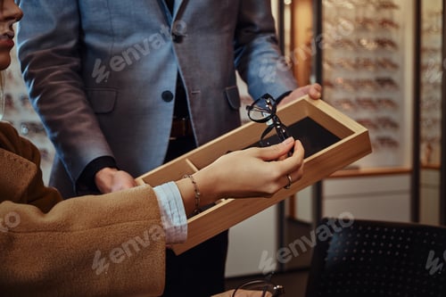 Preview: Lady is choosing new glasses at store
