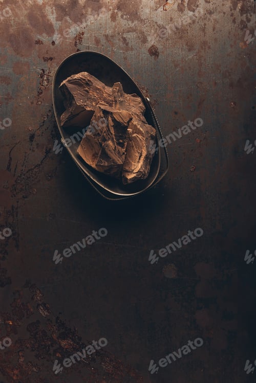 Preview: top view of delicious chocolate pieces on dark rustic surface