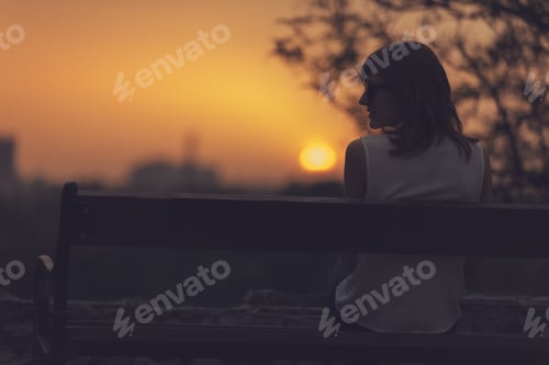 Preview: Woman Sitting On A Bench And Watching The Distant City Scenery.