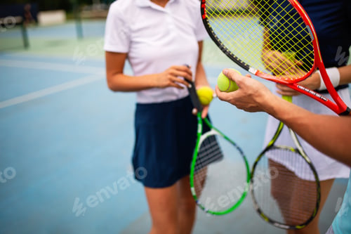 Preview: Portrait of fit happy women playing tennis together. People sport concept