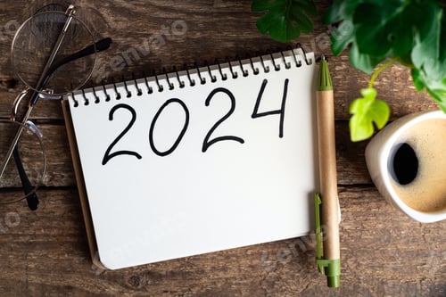 Preview: 2024 New year resolutions on desk. 2024 goals list with notebook, coffee cup, plant on wooden backgr