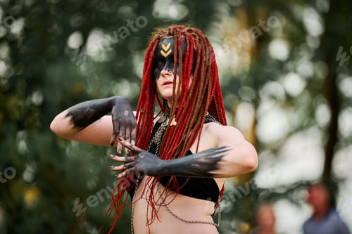 Preview: Mythological dancing girl faun on green lawn in public park outdoor art dancing event
