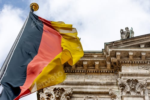 Preview: German flag waving in front of the building in Munich, Germany