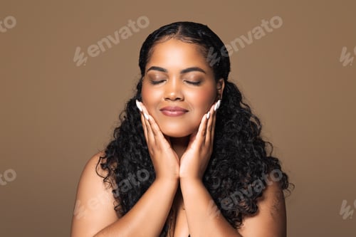 Preview: Perfect skin. Beautiful brazilian plus size woman touching her face with pleased face expression