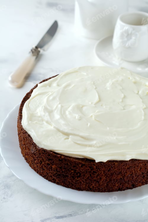 Preview: Carrot cake with cream on light background. Selective focus