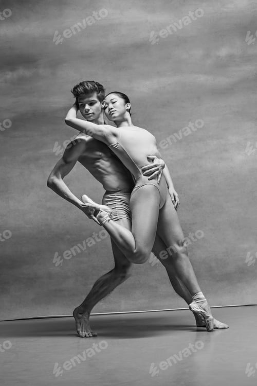 Preview: Couple of ballet dancers posing over gray background