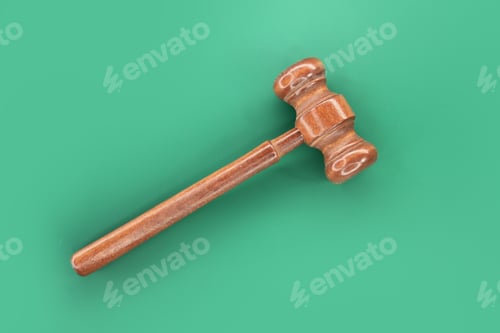 Preview: Wooden judge's gavel isolated on green background