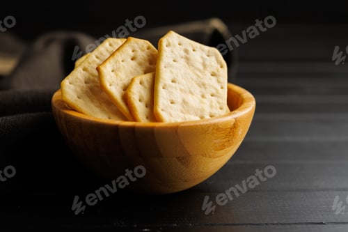 Preview: Salted Crackers in bowl Against a Dark Background