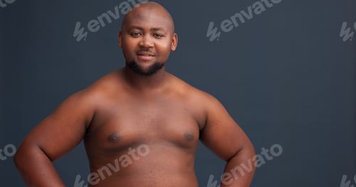 Preview: Black man, portrait and topless in studio with body positivity, confidence and smile at space. Plus
