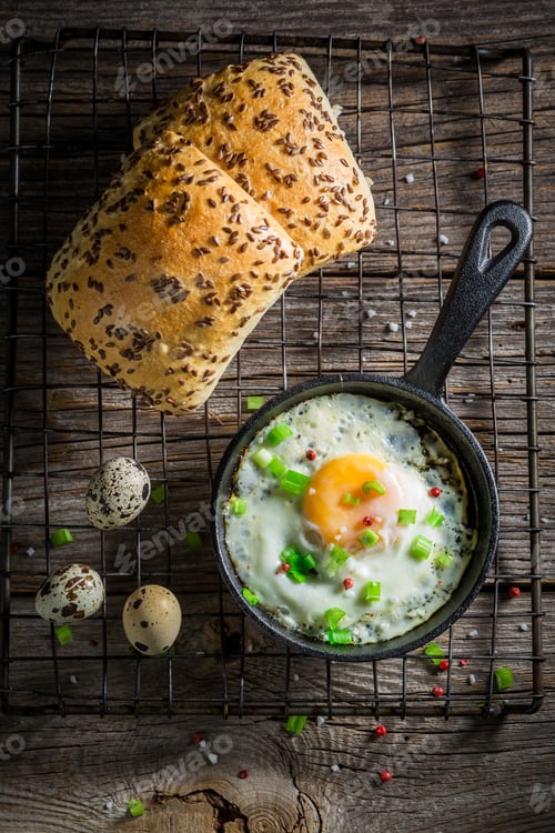 Preview: Tasty and fresh fried eggs served with chive and roll.