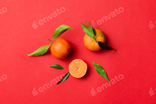 Preview: Many fresh ripe mandarin with green leaves on colored background, top view, space for text